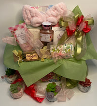 Load image into Gallery viewer, Let the intoxicating aroma of our foaming sugar scrub whisk you to a blissful relaxation.
But the pampering doesn't stop there! Treat your taste buds to the delightful flavors of raspberry cookies and truffles, perfectly paired with a soothing cup of tea. And don't forget the pièce de résistance—a stunning large soap that's both a feast for the eyes and a treat for the skin.
Your gift will come wrapped in cello, with a beautiful handmade bow and card for your recipient. Contact us if we can further assist