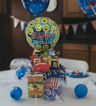 Load image into Gallery viewer, Lights, camera, action! "Happy Birthday, Movie Box" steals the show as the ultimate surprise for your little star or superstar. Packed with excitement and giggles, this popcorn box is a treasure trove of joy with candy, stickers, crayons, treats, even a Nerf football, small games, and more! Customizable to the max, we'll sprinkle in some glow sticks, candy, balloons, cards, popcorn, and more, all bundled up with love and a fabulous bow. Lights dim, the curtain rises, and it's popcorn time!