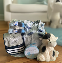 Load image into Gallery viewer, Introducing our "Our One-of-a-Kind Baby Boy" canvas basket – it's like a treasure chest for the tiniest adventurer! We've curated this bundle of joy with oodles of cuteness and practicality. From a snuggle-worthy plush blanket to bibs softer than a cloud, it's a symphony of super softness! And that's not all – we've got wash towels softer than a marshmallow, PJs that'll make bedtime a breeze, and an adorable plush toy just waiting for some baby giggles.