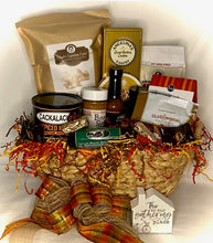Load image into Gallery viewer, Within our beautiful reusable basket lies a treasure trove of gourmet delights, carefully chosen to tantalize your taste buds. From the irresistible crunch of Carolina Gourmet Popcorn to the zing of Cackalacky Peanuts, the rich flavors of Bone Sucking Spices, and the sweetness of Jam or Honey - each item is a testament to the culinary richness of the South. Savor the dance of flavors with our handpicked assortment of salsa, candy, crackers, beef sticks, cheese, cookies, and other delectable surprises.