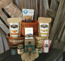 Load image into Gallery viewer, Every basket is adorned with love, with products selected by us, then wrapped in cellophane, accompanied by a heartfelt notecard, and crowned with a beautiful handmade bow.
We offer the convenience of local delivery or nationwide shipping, ensuring that your loved ones, near and far, can experience a slice of Southern love. Choose from our carefully designed options to send a touch of Southern charm to your special someone.