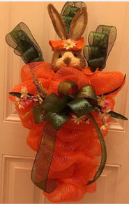 Our Spring Bunny Decor says "Hello and Welcome!"  This handmade wall or door decor is made with pretty orange, green mesh ribbon, embellished with silks, and a bunny with a beautiful handmade bow. Perfect for any door or wall decor. It measures 34" x 22" it can be shipped nationwide. Please allow 1-2 weeks for delivery. Chat with us on our website or call/text, email us and we will gladly assist you at 704-526-7407 or perfectselectioncreativegifts@gmail.com. Let us do the legwork for you!