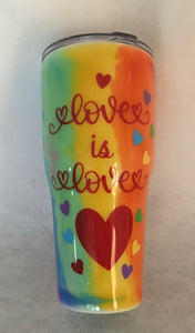 "I Love You a Million Rainbows"... is decorated with #PRIDE, Love is Love, Be You, and #Love Wins. This is a stainless tumbler it is great for any hot or cold drink and can hold 30 fluid ounces with a lid. It is decorated with vinyl, ink, and resin. These tumblers can be ready in one to two weeks. We can personalize and customize these tumblers. We carry several different stainless tumblers in a variety of sizes.
