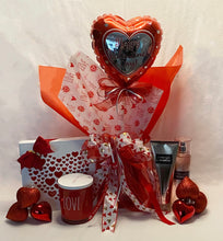 Load image into Gallery viewer, Valentine's Day Kisses & Hugs! One of our Favorites! This is our Valentine's Day flip top, black and white checkered box with Happy Valentine's Day written on the top. Perfect for your special Valentine! These reusable boxes are fun to use for keepsakes, photos, or any sort of memorabilia. It’s filled with a variety of delicious hand-selected treats for your favorite Valentine. It includes a box of Chocolates, a Large Candle, a Bath & Body Lotion, a Bath & Body Spray, a Balloon, and so much more!