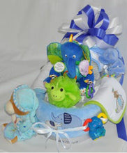 Load image into Gallery viewer, And oh, those adorable outfits and teeny socks, they're in on the fun too!
But wait, there's more! This masterpiece comes all decked out – bathing goodies, cute-as-a-button toys, and so much more. You'd think it's a parade of joy!
Now, imagine it all snug in a cello wrap, crowned with a beautiful handmade bow so splendid that it's practically a work of art. And guess what? It's tailor-made for the royal highness, with customizations galore – from gender to size to color.