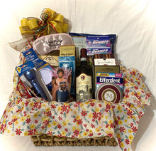 Load image into Gallery viewer, You'll find treats to eat and chuckle at in this beautiful reusable basket. There's Red wine, Focaccia crisps, a Fruit Medley, Cheese, Cookies, Wine and Cheese Biscuits, a Golden Girls glass, an Adult Diaper, a Flash Light, an Ice Pack for Aching Bones, Reader Glasses, Bath Soak for Aches, Efferdent, Denture Cream, a Sleeping mask that says "Wake Me Up For Wine!" and much more!
You should've seen the laughter this gift caused! LOL!