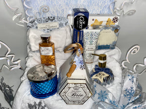 In our large gift box, we have included: A gorgeous flip-top winter wonderland box reusable box, A Winter White Cozy Throw Blanket, A Large Fresh Snowfall fragrant blue candle, A Large Nordic Pine scented handsoap shaped in a silver ornament shape, A Soft white headband, A double pack of Livegreen Looftahs,&nbsp;Bath &amp; Body's Pure Wonder Lotion and Bath and Body's Pure Wonder Body Wash, A Cozy pair of socks, A box of Walker cookies, creamy Brie cheddar cheese with a cheese spreader, Crispy water cracker