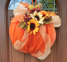 Load image into Gallery viewer, Welcome the season in style with our &quot;Autumn Harvest&quot; handmade pumpkin decoration, a charming addition to any door, wall, classroom, or office space. Crafted with vibrant orange deco mesh and trimmed with silk leaves, sunflowers, a burlap stem, and a handmade burlap bow, this piece brings the warmth and beauty of fall into any setting. Measuring approximately 18&quot; x 20&quot; x 5&quot;, it features a cheerful &quot;Welcome Fall&quot; message and can be customized with additional ribbon colors to match your style.