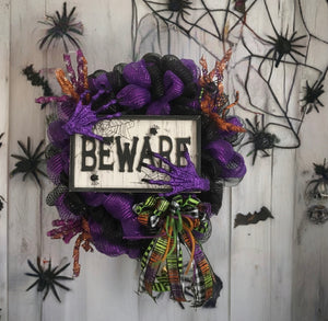 This Halloween, let us weave an enchanting spell and transform your space into a haunted wonderland! Embrace the frightful fun and let our "BEWARE" wreath set the tone for a spooktacular celebration! Allow us to make your Halloween an unforgettable and spine-chilling experience!