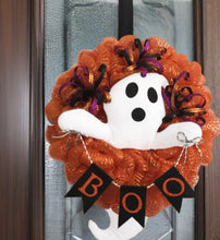Load image into Gallery viewer, Look alive, fright fans! Our handmade mesh wreath featuring a white ghost peeking through is the ideal adornment for your haunters and horror-seekers. Composed of orange mesh, a fabric ghost with shimmering picks, this wreath stands 26&quot; tall x 18&quot;wide, and 6&quot; deep. Perfect for any home, rental, or schoolroom, it&#39;s sure to be a hit with the wee monsters. Ghouls just wanna have fun with this wreath as they are welcomed! Order yours now!
