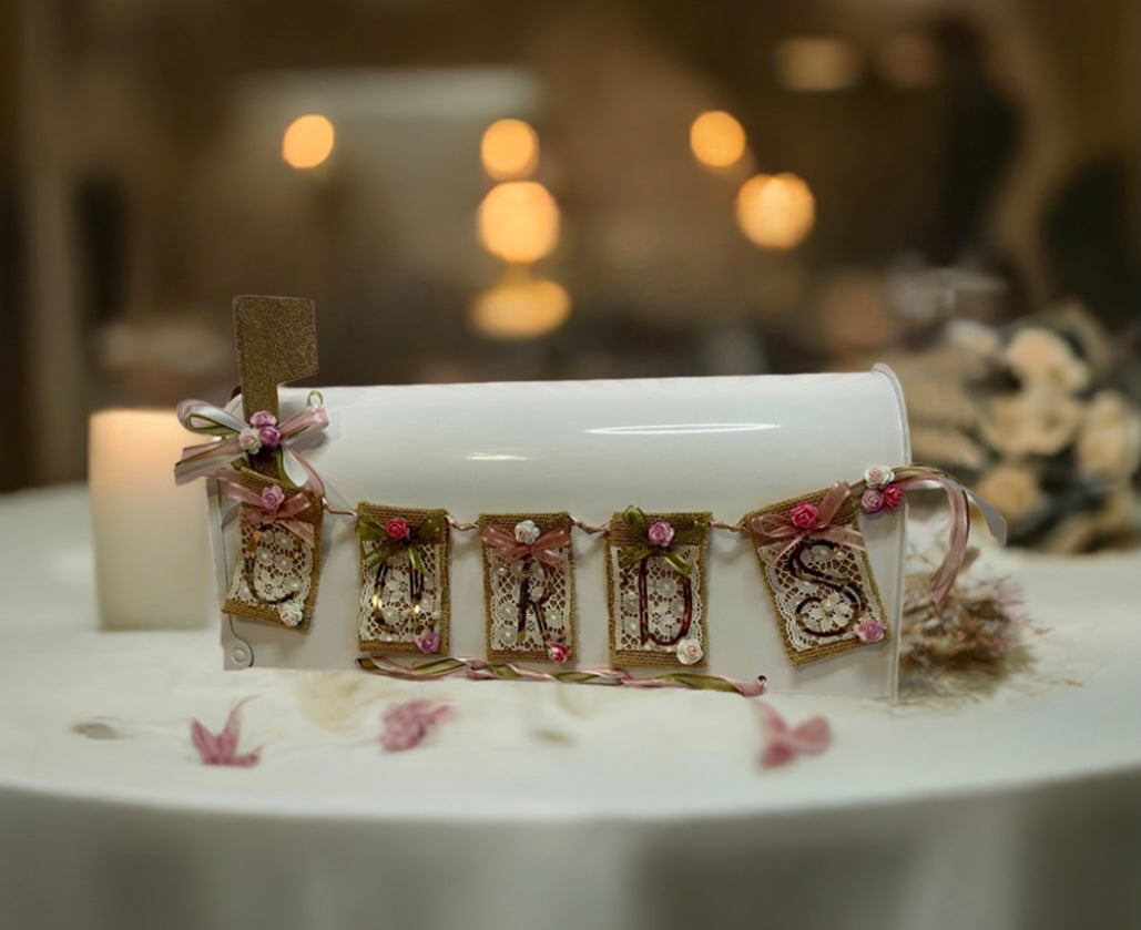 Our custom Bridal Day Card Box is the perfect way to collect cards on your special day. This luxurious full-size mailbox is no ordinary box it has been adorned with exquisite rose gold vinyl, amore rose and sage colored ribbon, and beautiful silk mini roses.