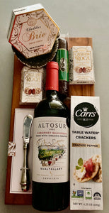 The Savor & Sip Board is the perfect blend of style and flavor, featuring a 16" x 8" charcuterie board with a 5/8" thickness and a versatile dish for cheese, olives, or dip.

This elegant gift includes:

A bottle of wine.
A creamy Brie cheese spread.
Crisp water crackers.
A savory sausage stick.
Decadent Cashew Roca, and more.
It’s ideal for celebrations, gifting, or indulging in a little luxury!