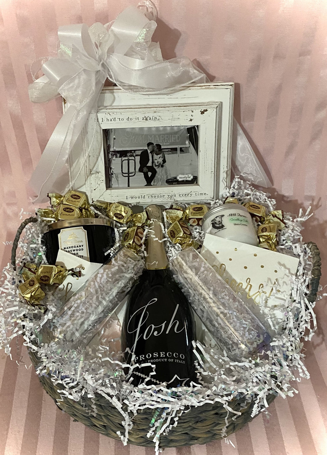 Bride & Groom Celebratory Gift ~ a beautifully put-together gift basket with all the right romantic necessities for the perfect couple to enjoy! This beautiful reusable whitewash gray basket includes a bottle of Prosecco, two stemless flutes, a pretty jar of lotion, a beautiful picture frame that says's 