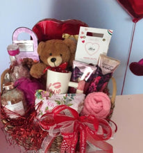 Load image into Gallery viewer, But hold onto your heartstrings—here&#39;s the sneak peek of the beautifully handselected gift items we have chosen for this gift. A Valentine Chocolate Heart (oh-so-sweet!), chocolate truffles to swoon over, a cuddly Teddy Bear to snuggle, a mug that&#39;s just as beautiful as your love story, a Bath and Body Facial Scrub to glow like a star, Body Lotion for silky-smooth skin, or body lotion, flavored candies for a pop of sweetness, Chocolates that&#39;ll make taste buds dance,