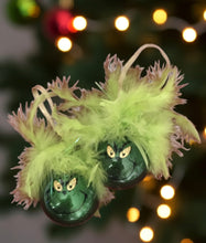 Load image into Gallery viewer, Calling all Grinches (and Grinch-lovers)! Meet our handmade &quot;Grinch Christmas Ornaments&quot;, glittery inside, feathered and fun outside, and ready to bring mischief to your tree.