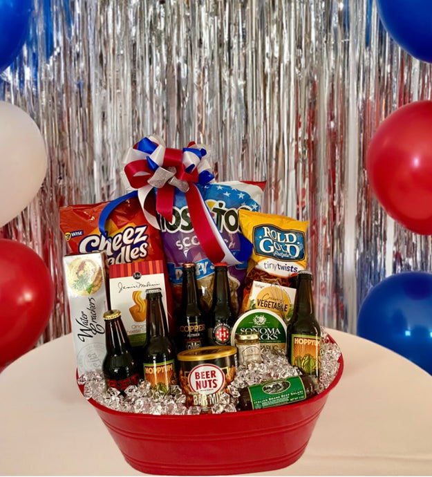 Let the Celebration Begin is the ideal party-starting gift basket! It contains an exclusive selection of snacks, including Cheez Doodles, Tostitos Scoops, Rold Gold Pretzels, Cheese, Sausage Sticks, Mustard, Cheese Straws, Nuts, Water Crackers, and so much more! It also includes a unique collection of craft beers from North Carolina. Perfect for Father's Day, Mother's Day, and any special occasion, this gift tub is guaranteed to heighten your celebration. It can also be made with soda 