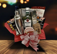 Load image into Gallery viewer, &quot;Did someone say RUM?&quot;... A &quot;BEST SELLER!&quot;&nbsp;More Fun with Rum is our perfect rum drinkers gift basket! Deliciously put together these hand-selected treats will make your rum lovers enjoy Fun Times! We&#39;ve included a delicious variety of treats in our decorative reusable container, Superior Bacardi Rum, Butter Toffee Pretzels, Water Crackers, Brie Cheese, Bruchetta Crackers, Pimento Stuffed Olives, Pirouline wafers, Sausage Stick, Full-Size Stainless Steel Shaker with a shot measuring cup, spoon, two pour