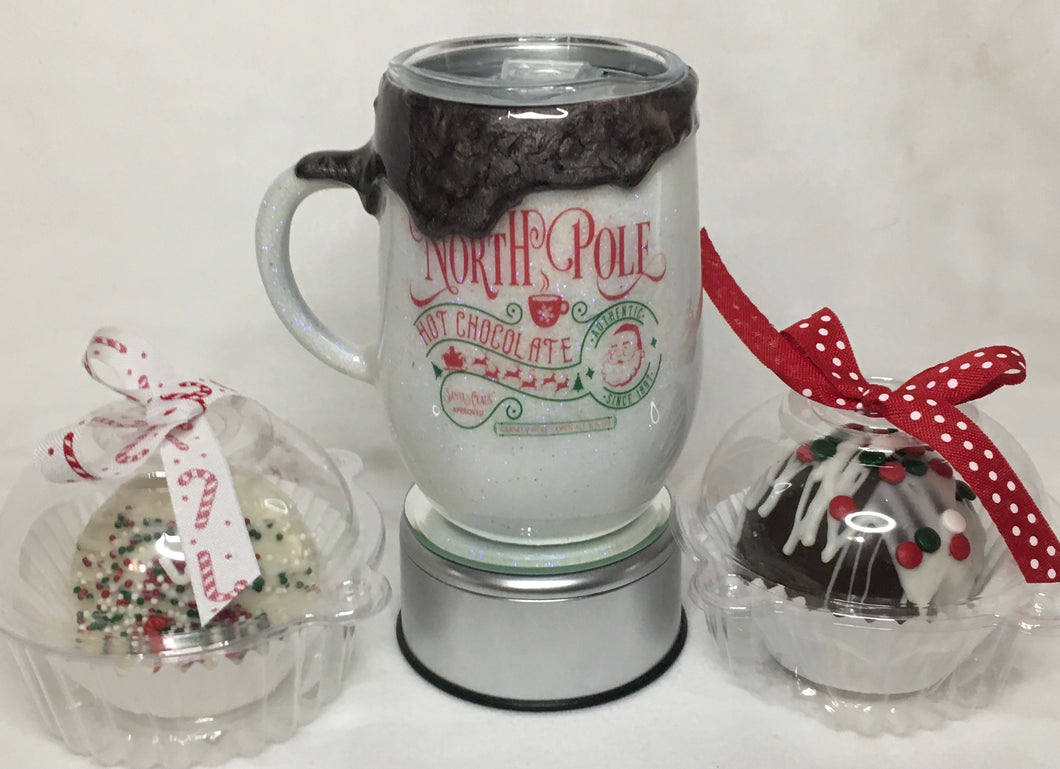 North Pole Dripping Hot Cocoa Mug is a 15-ounce stainless steel mug with a lid. It is decorated with extra-fine white iridescent glitter, vinyl, and FDA-approved epoxy. These mugs keep your drinks hot and in style! We can customize by size, color, and quotes. We can add monograms, names, and the North Pole label of your choice. This cup with one name is $45.00. Hot Cocoa Bombs NOT INCLUDED. 