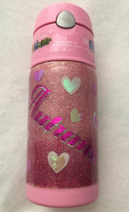 Pink Heart's kid's cup is a perfect gift for any child! This cup is a 12-ounce, spill-proof cup that can hold cold and warm drinks for any child. We have handmade this cup with extra fine glitter, vinyl, and FDA compliant epoxy. We can design your cup with any kind of personalization you like! This cup was a custom order for a little girl named Autumn. We carry several different stainless tumblers in a variety of sizes some have lids and straws.