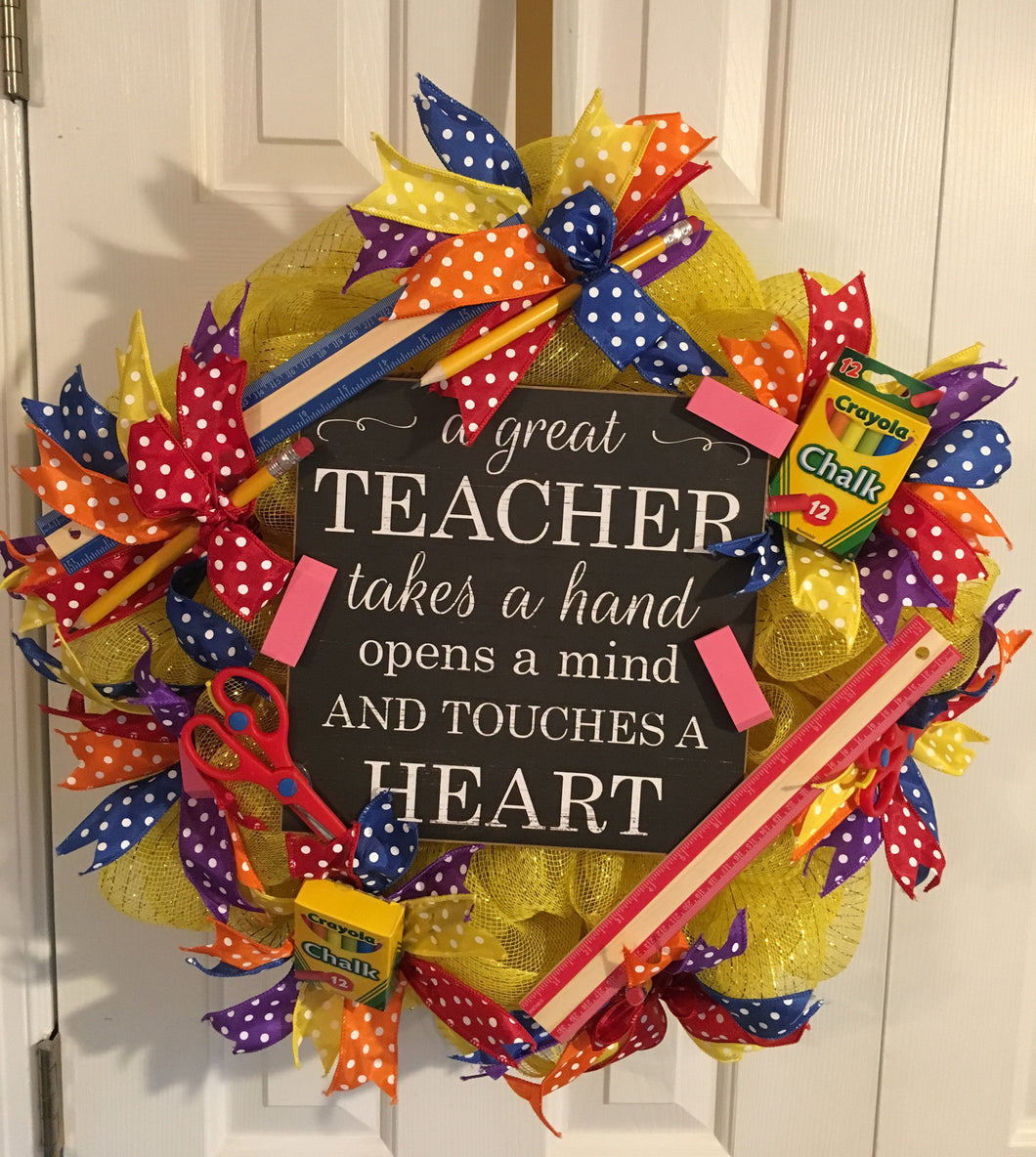 Back to School wreath would be a beautiful decoration for any classroom door/wall or teacher's house. This wreath is decorated for a New or Returning Teacher. The plaque reads:  A Great  TEACHER  takes a hand  opens a mind  AND TOUCHES A  HEART  It is approx. 34” in diameter decorated with assorted ribbon and school supplies such as pencils, scissors, erasers, and rulers. This may be shipped nationwide. Please allow 2 weeks for orders to go out. This wreath would make any teacher feel special! 