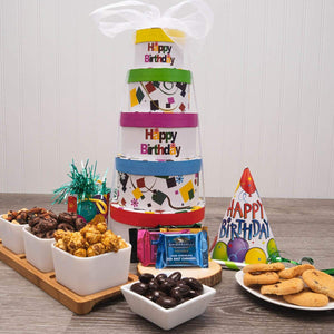 Say “Happy Birthday” with this festive birthday-themed gift tower. Five bright and cheery boxes are filled with our favorite birthday celebration treats. To please their sweet tooth, we’ve hand-selected gourmet popcorn, cookies, snack mix, and candies inside the tower boxes. This gift is sure to make their birthday a memorable one! Great for adults and kids alike.