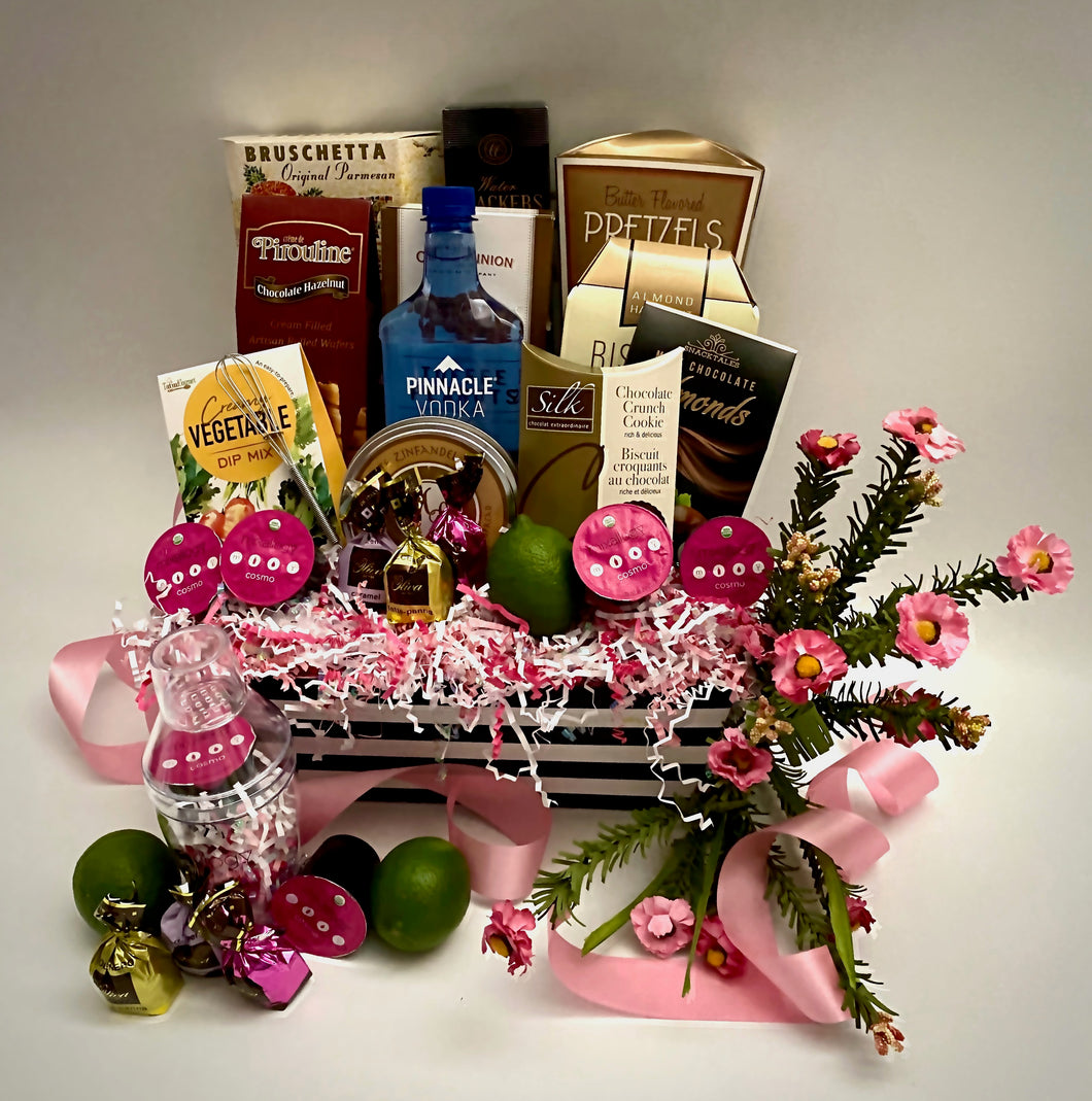 Get ready for a fun and sassy happy hour with Cosmo Cocktail therapy! A gift that looks this good is sure to be a hit! This beautifully put-together market box is perfectly curated with treats they will enjoy! We've included Butter Toffee pretzels, Bruchetta chips, Cheese, Water crackers, Pirouline wafers, Chocolate covered almonds, Cheese straws, Toffee nuts, Chocolate silk cookies, Vegetable dip, Cosmo mixers, with stainless steel shaker (NOT shown here), Pinnacle Vodka, Chocolates, and much more! 