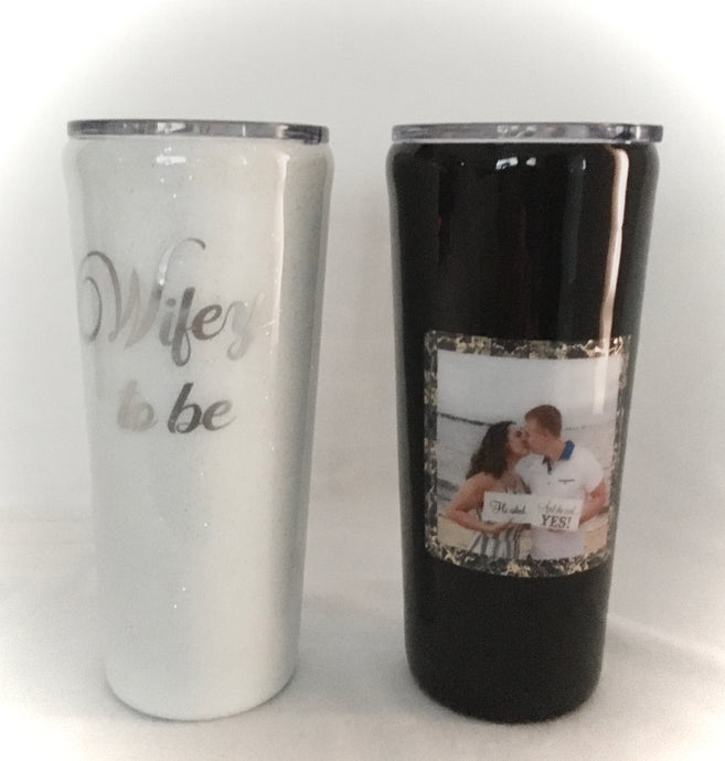 Our Bride & Groom-to-be tumblers make the perfect gift for any future couple. These 20-ounce tumblers will keep their drinks hot/cold for hours. These particular cups are handmade with photos provided by our customer, vinyl, extra fine glitter on the brides' cup, grooms cup hand-painted, and epoxy on both. These cups come with closable lids. We can personalize and design these tumblers any way you like. We can add monograms, names, sayings, etc.