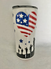 Load image into Gallery viewer, &quot;Land of the Free Because of the Brave&quot; is a peek a boo cup which is a different technique than the ordinary one. It has a few extra steps with inking. It is a handmade 20-ounce tumbler that is stainless steel and great for any hot or cold drinks. It comes with a lid and can be personalized for him/her. We can add this tumbler to a gift basket as well. It can be a perfect gift for anyone. It is decorated with vinyl, ink, and resin. These tumblers can be ready in one to two weeks.