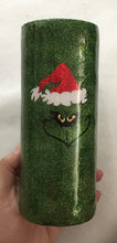 Load image into Gallery viewer, &quot;You&#39;re A Mean One Mr. Grinch!&quot; is a great cup for anyone to enjoy! This cup has the saying &quot;Maybe Christmas he thought, doesn&#39;t come from a store Maybe Christmas perhaps means a little bit more. ~The Grinch~ on one side and The Grinch picture on the other side. We can customize by colors, adding names, and quotes. This tumbler is a great way to carry your hot or cold drink in seasonal style! It holds 20 fluid ounces and comes with a lid. It is decorated with vinyl, extra fine glitter, and resin.