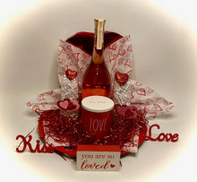 Load image into Gallery viewer, Our special selection of treats is perfect for your Valentine to share! This beautiful heart cutout charger comes with a large heart box of chocolates, two flute glasses, a beautiful candle, and a bottle of Sofia Rose or your choice of Prosecco, Red, or White wine of your choice! Nothing says Happy Valentines Day &amp; Relax with this hand-selected gift! (Please select wine choice in the dropdown.) This gift will come wrapped in shrink wrap with a notecard and a beautiful handmade bow.