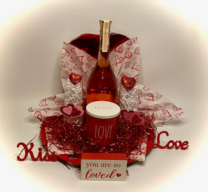 Our special selection of treats is perfect for your Valentine to share! This beautiful heart cutout charger comes with a large heart box of chocolates, two flute glasses, a beautiful candle, and a bottle of Sofia Rose or your choice of Prosecco, Red, or White wine of your choice! Nothing says Happy Valentines Day & Relax with this hand-selected gift! (Please select wine choice in the dropdown.) This gift will come wrapped in shrink wrap with a notecard and a beautiful handmade bow.
