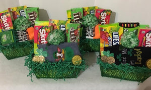 St. Patrick's Day Sunshine! Is a special gift for your Sweet Little Leprechaun! We can fill your gift with candy, toys, gift cards, and more. We have a variety of containers and delicious treats for your little Irish person! Order yours ahead for Saint Patrick's Day! Your gift will include candy, socks, and a mini-toy. It will come wrapped in a cello with a notecard and a handmade bow. Due to such high demand, we no longer carry the basket in the photo but do have other containers (also green).