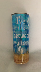 "I've got sand between my toes" is a 20-ounce skinny tumbler that is a bit more slender than a regular 20-ounce cup. This particular cup is a beach theme made with inking technique, vinyl, glitter, and extra fine sand. It is handmade and is stainless steel and great for any hot or cold drinks. It comes with a lid and can be personalized for him/her. We can add this tumbler to a gift basket as well.