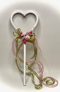 These handmade flower girl wands are so adorable! These wands are a solid one-piece 3D printed heart wrapped with white ribbon and embellished with amore rose, sage ribbon, and mini rosettes. Approximately 12" long by 4" wide. We can ship these wands nationwide.