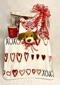 "Hugs & Kisses" xoxoxo is the perfect Valentine's Day Gift for that Special Someone! This beautiful flip-top box is filled with lots of hugs and kisses. Your Valentine will feel the LOVE! One of our "Best Sellers!" Included is: Large Beautiful Decorative Flip Top Box or basket, a Super-soft plush throw blanket with X's & O's, and Hearts, or a throw of equal or greater value. A Box of Delicious Chocolates, Bath and Body Lotion, Bath and Body Spray, A Wonderful Full-Size Candle,