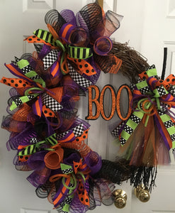 Witches Broom Wreath is a handmade grapevine wreath embellished with glitzy variety mesh, assorted ribbons, witches broom, BOO sign, and a variety of tulle. This wreath will put all your guests in the Halloween mood! It measures approximately 26" x 30". Please inquire if you would like a smaller or larger wreath. Great for any door or wall for Halloween. *Order Now for on-time delivery! We deliver locally and do ship. When ordering 2 let us know if they will go to the same entrance.