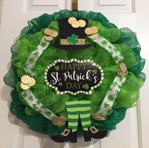 Happy Saint Patrick's Day Wreath is a two-toned green mesh wreath approximately 24" in diameter and decorated with gold coins, ribbon, and a wooden sign that says "Happy St. Patrick's Day." These can be ordered now and can be delivered within a week or two. We can add additional ribbons to wreaths and reserve the right to substitute signs. We can ship this nationwide. The back of the wreath is covered with felt to protect walls or doors.