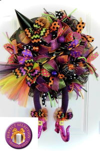 Our Wacky Witch Wreath is a one-of-a-kind wacky wreath made of mesh, decorated with colorful Halloween ribbons, embellishments, a witch's hat, legs, and a broom! This wreath says "Enter All!!! It measures approximately 30" x 22" x 6" and is perfect for any door or wall. We may substitute embellishments for this wreath. Please allow ample time for delivery. Order yours Now for on-time delivery! These are handmade and made to order. Let us design and create your Wacky Witch Wreath for your Halloween decor!