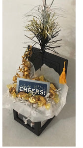 Graduation Cap Photo Gift Box is the perfect gift no matter what age your graduate is. We can customize this gift with a variety of candy, gift cards, and more. This photo box includes candy and a card. This is just an example of gifts. Let us know if we can customize this for you. We can add this gift box to another gift as well. Your gift will come cello wrapped, with a notecard and handmade bow. We can ship nationwide. Money cards may be added such as Amazon cards, Starbucks, Stores, and more.