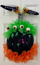 Load image into Gallery viewer, Our Witch in Cauldron is a Halloween “BEST SELLER” This one of kind door or wall décor will make your little goblins laugh out loud! This handmade mesh wreath is perfectly decorated with witches&#39; legs, spiders, bubbles, eyeballs, and flames in a handmade mesh cauldron. This wreath says it all &quot;Enter All Trick-or-Treaters!&quot; 