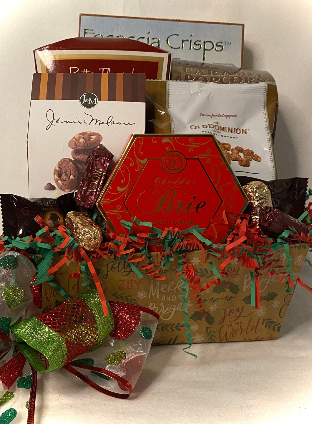 Cheddar Brie Cheese Spread, Marich Chocolate Toffee Almonds, Godiva Chocolates, Almond Roca, and more! Wrapped in a cello, with a notecard and a beautiful handmade bow. We can ship this gift also!