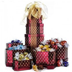 Tower of Decadence is a gourmet assortment of chocolate goodies that make this gift the perfect pick for any occasion. Sure to satisfy any chocolate craving, it's a great way to show you care. These elegant boxes measure approximately: 6 x 4-1/4" 5-1/4 x 3-3/4" 4-3/4 x 3-3/4" 4-1/4 x 3" 3-3/4 x 2-1/2" Total height approx: 13" These boxes can be shipped nationwide or delivered locally. 