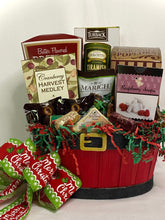 Load image into Gallery viewer, Caramel Popcorn for that sugary sweet fix, Rolled Wafers, Crackers for our cheese delight, Harvest Medley for a burst of holiday flavor, a Meat Stick to spice things up, Cheese Spread for that savory touch, Chocolate, delightful Cookies, a variety of sweet and savory treats, and so much more! Phew, that&#39;s a sleigh full of deliciousness packed in one jolly basket!
There&#39;s more merriment to this holiday surprise! Each treat-filled delight is snugly wrapped in shrinkwrap with a card and a handmade bow.