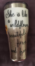 Load image into Gallery viewer, &quot;She is like a wildflower beautiful, fierce, and free.&quot; A great tumbler for any special lady! This tumbler was custom made for a dental hygienist for Dental Hygiene Appreciation Week. She loves sunflowers.  This is a stainless tumbler it is great for any hot or cold drink and can hold 30 fluid ounces with a lid. It is decorated with vinyl and resin. These tumblers can be ready in one to two weeks. We can personalize and customize these tumblers. 